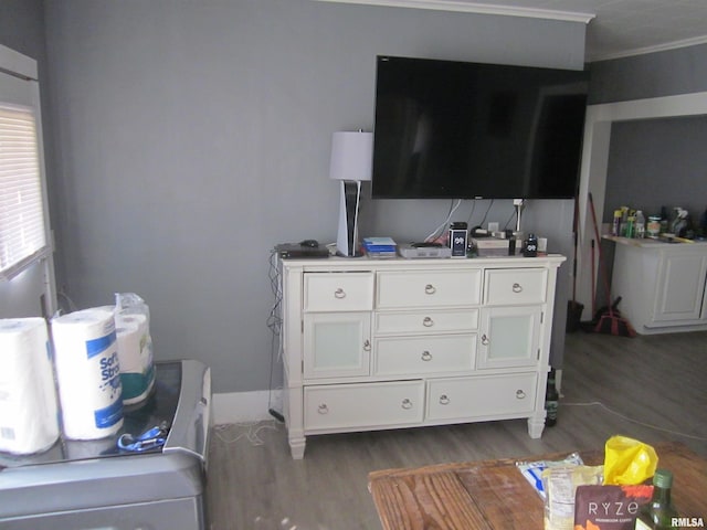 bedroom with dark wood-style flooring and ornamental molding