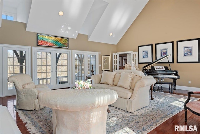 living area with a wealth of natural light, french doors, high vaulted ceiling, and wood finished floors