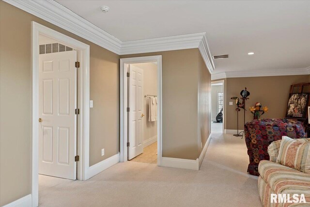 hallway with carpet flooring, baseboards, crown molding, and visible vents