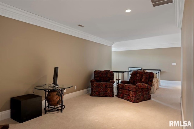 sitting room with visible vents, an upstairs landing, carpet flooring, and crown molding