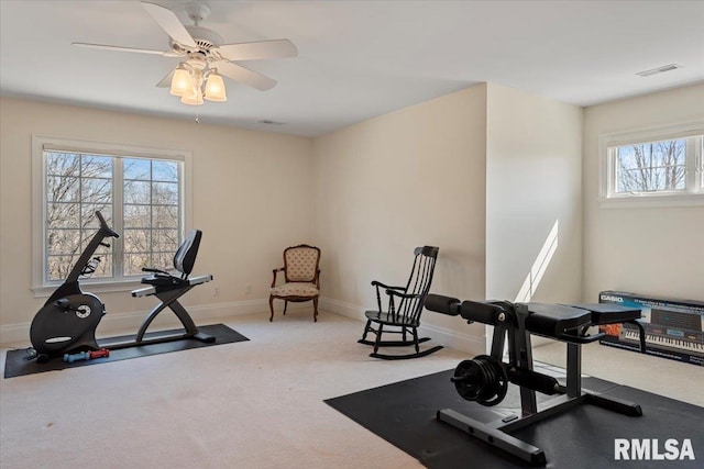 exercise area featuring visible vents, carpet flooring, baseboards, and ceiling fan