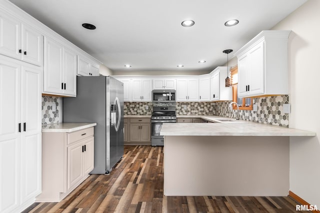 421 Turtle Dove Dr, Sherman, IL 62684 - kitchen featuring dark wood-style flooring, a sink, stainless steel appliances, a peninsula, and light countertops