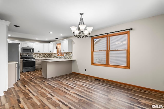421 Turtle Dove Dr, Sherman, IL 62684 - kitchen featuring dark wood finished floors, stainless steel appliances, a peninsula, and decorative backsplash