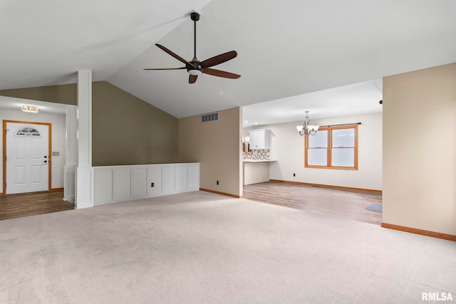 421 Turtle Dove Dr, Sherman, IL 62684 - unfurnished living room with carpet flooring, visible vents, baseboards, vaulted ceiling, and ceiling fan with notable chandelier