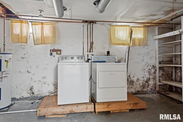 laundry area featuring water heater, washing machine and dryer, and laundry area