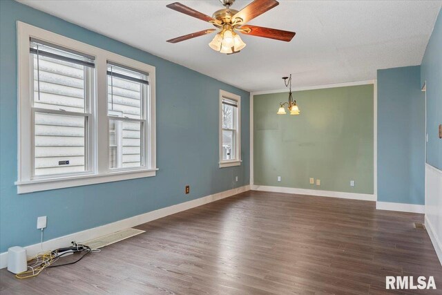 unfurnished room with ceiling fan, baseboards, dark wood-style floors, and visible vents
