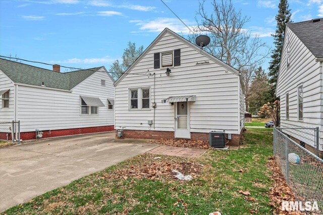 rear view of property with fence and central AC unit