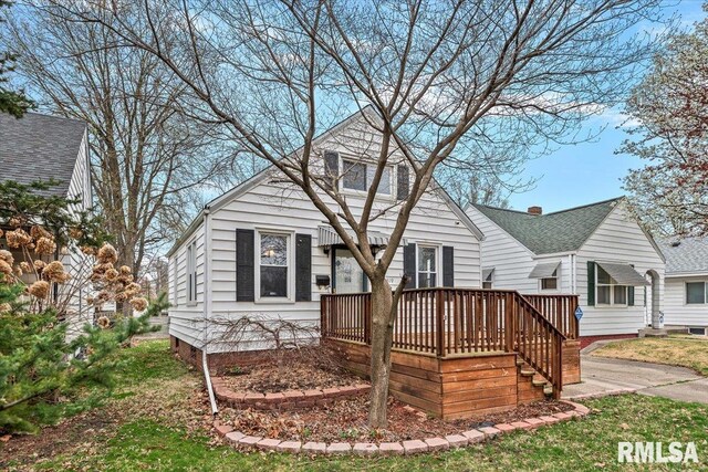 rear view of house with a wooden deck