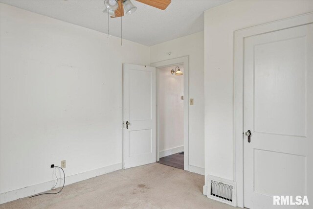 unfurnished bedroom with light carpet, baseboards, a ceiling fan, and visible vents