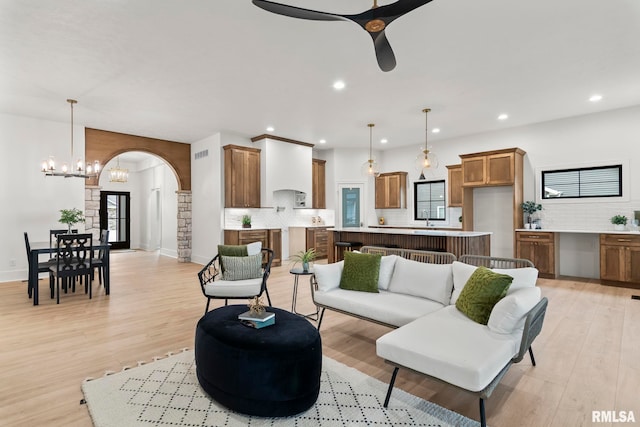 5819 Kelley Pointe Dr, Springfield, IL 62711 - living area with a fireplace, arched walkways, ceiling fan with notable chandelier, recessed lighting, and wood finished floors