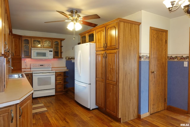 132 W Coal St, Wataga, IL 61488 - kitchen with white appliances, dark wood-style flooring, a sink, light countertops, and brown cabinets