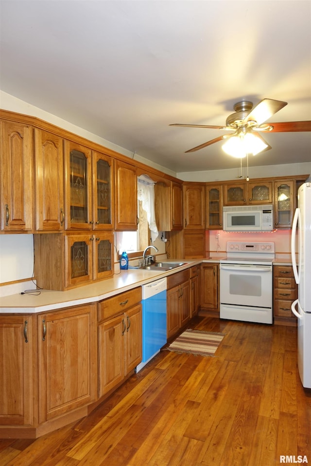 132 W Coal St, Wataga, IL 61488 - kitchen with white appliances, brown cabinetry, a sink, hardwood / wood-style flooring, and light countertops