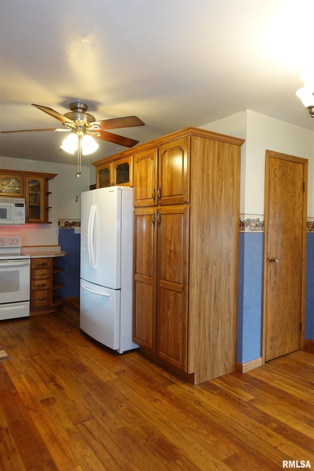 132 W Coal St, Wataga, IL 61488 - kitchen featuring glass insert cabinets, white appliances, dark wood-type flooring, and ceiling fan