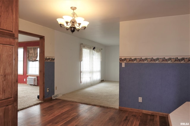 132 W Coal St, Wataga, IL 61488 - empty room with visible vents, an inviting chandelier, wood finished floors, and a healthy amount of sunlight