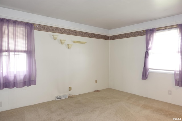 132 W Coal St, Wataga, IL 61488 - empty room with carpet flooring, a healthy amount of sunlight, and visible vents