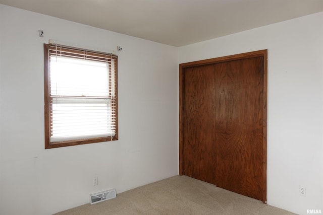 132 W Coal St, Wataga, IL 61488 - unfurnished bedroom with a closet, visible vents, and carpet floors