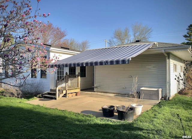 132 W Coal St, Wataga, IL 61488 - rear view of house with a patio, a yard, and metal roof