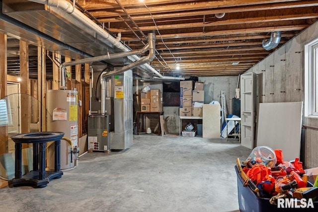 unfinished basement featuring heating unit and gas water heater
