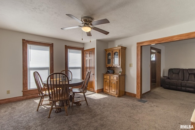 253 Day St, Galesburg, IL 61401 - dining room with visible vents, light colored carpet, baseboards, and a ceiling fan