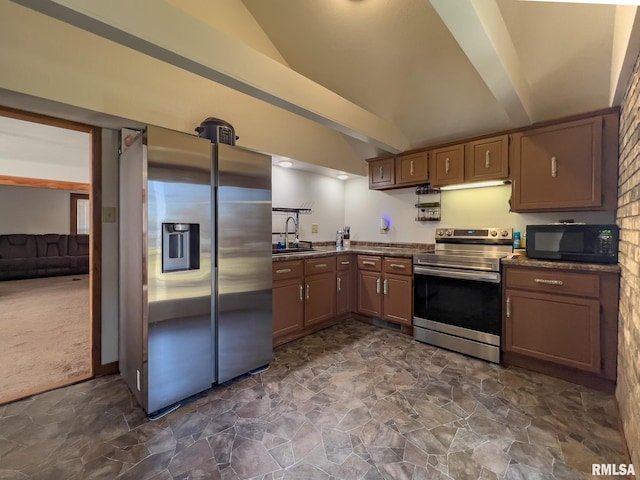253 Day St, Galesburg, IL 61401 - kitchen featuring vaulted ceiling with beams, stone finish flooring, dark carpet, stainless steel appliances, and a sink