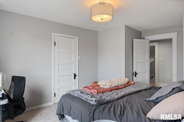 bedroom with baseboards and light colored carpet
