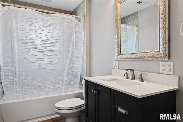 full bathroom featuring visible vents, toilet, vanity, and shower / bath combo with shower curtain
