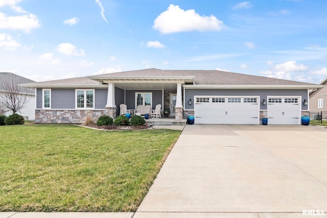 view of front of home featuring driveway, covered porch, stone siding, a front lawn, and a garage