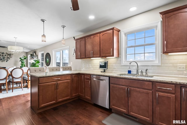 kitchen featuring a sink, a peninsula, stainless steel dishwasher, dark wood-style floors, and visible vents