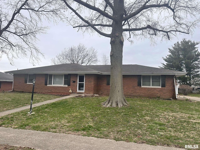 single story home featuring a front lawn and brick siding
