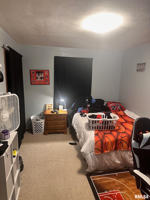 bedroom with carpet floors and a textured ceiling
