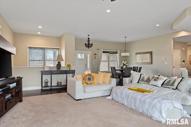 living room with a healthy amount of sunlight, baseboards, and recessed lighting