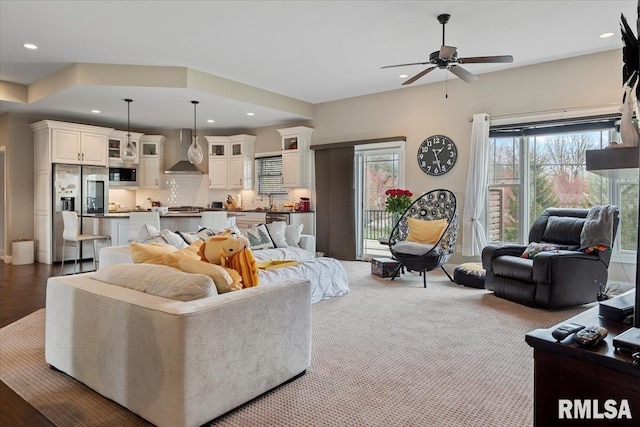 living room featuring a ceiling fan, plenty of natural light, and recessed lighting