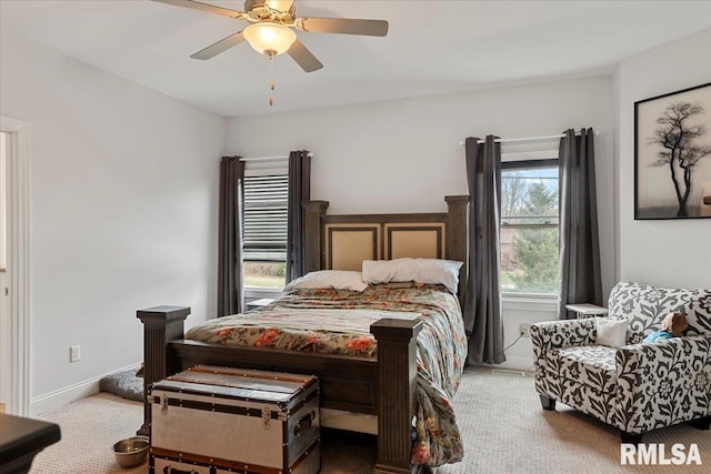 carpeted bedroom featuring ceiling fan and baseboards