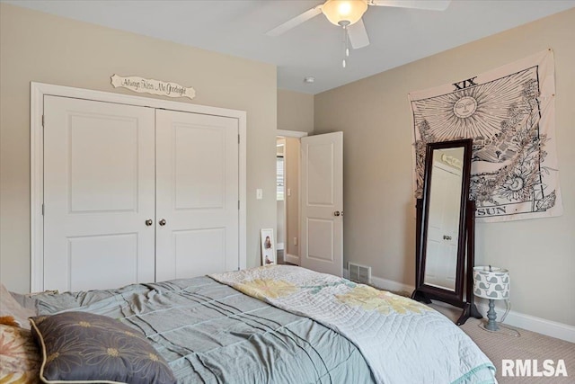 carpeted bedroom with a closet, ceiling fan, baseboards, and visible vents