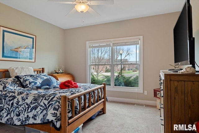 carpeted bedroom with baseboards and a ceiling fan