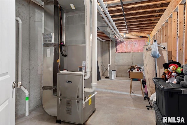 unfinished basement featuring heating unit