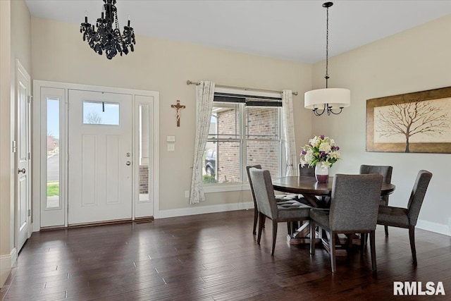 dining area featuring a healthy amount of sunlight, an inviting chandelier, and dark wood-style flooring