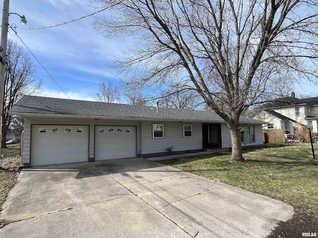 single story home with concrete driveway, a shingled roof, a garage, and a front lawn
