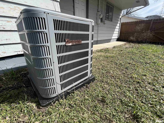 details featuring central air condition unit and fence
