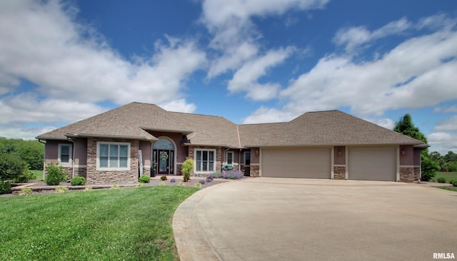 3337 Hunter Rd, Quincy, IL 62305 - view of front facade with stone siding, an attached garage, driveway, and a front yard