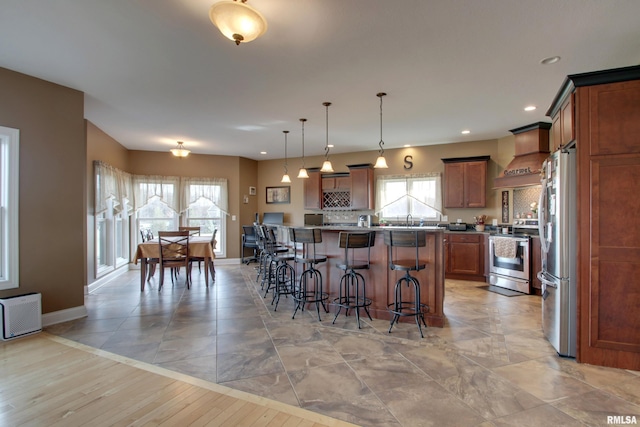 3337 Hunter Rd, Quincy, IL 62305 - kitchen featuring stainless steel appliances, a breakfast bar area, baseboards, healthy amount of natural light, and recessed lighting
