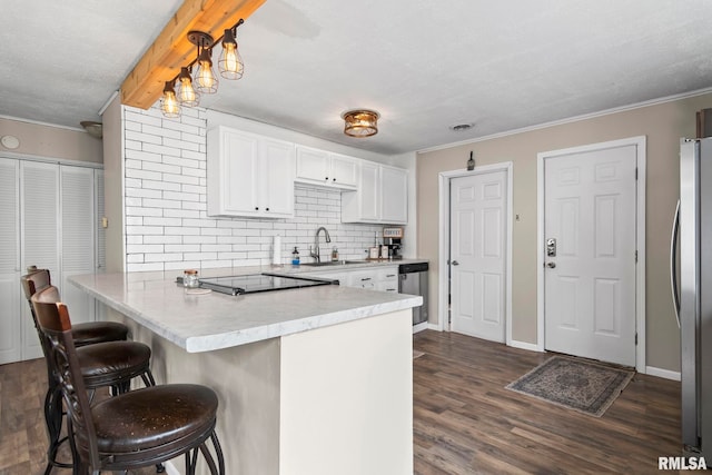 2364 E Keys Ave, Springfield, IL 62702 - kitchen featuring a peninsula, a sink, appliances with stainless steel finishes, white cabinetry, and backsplash