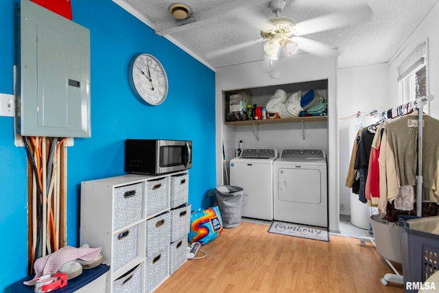 2364 E Keys Ave, Springfield, IL 62702 - washroom with electric panel, a textured ceiling, washer and dryer, a ceiling fan, and light wood-style floors