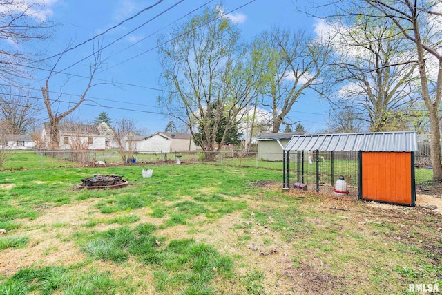 2364 E Keys Ave, Springfield, IL 62702 - view of yard featuring exterior structure, a fire pit, and an outbuilding