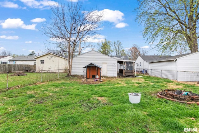 2364 E Keys Ave, Springfield, IL 62702 - back of house featuring an outdoor fire pit, an outbuilding, and a sunroom