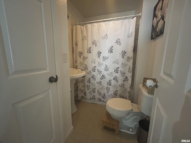 full bath with baseboards, a shower with shower curtain, tile patterned flooring, and toilet