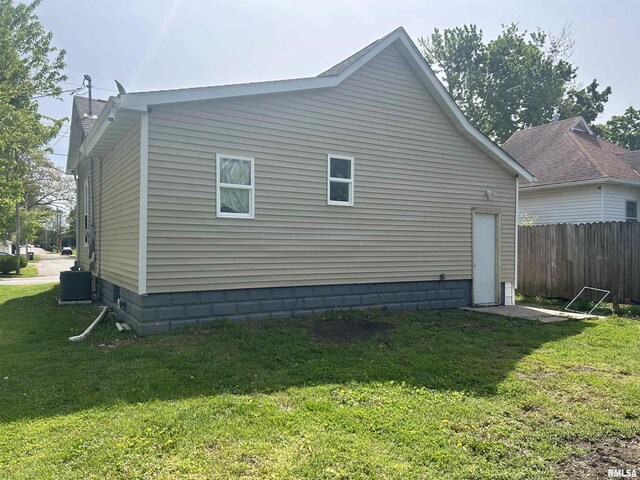 view of home's exterior with central air condition unit, a yard, fence, and a chimney
