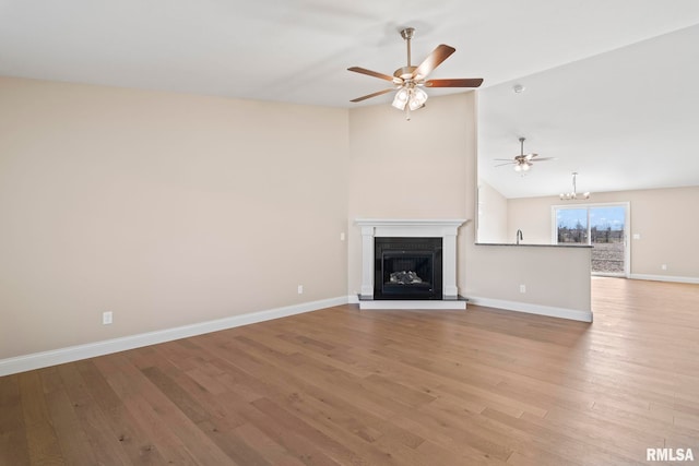 4602 Castle Pines Dr, Springfield, IL 62711 - unfurnished living room featuring lofted ceiling, ceiling fan, wood finished floors, baseboards, and a glass covered fireplace