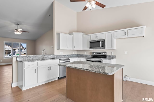 4602 Castle Pines Dr, Springfield, IL 62711 - kitchen with stainless steel appliances, open floor plan, a ceiling fan, baseboards, and high vaulted ceiling