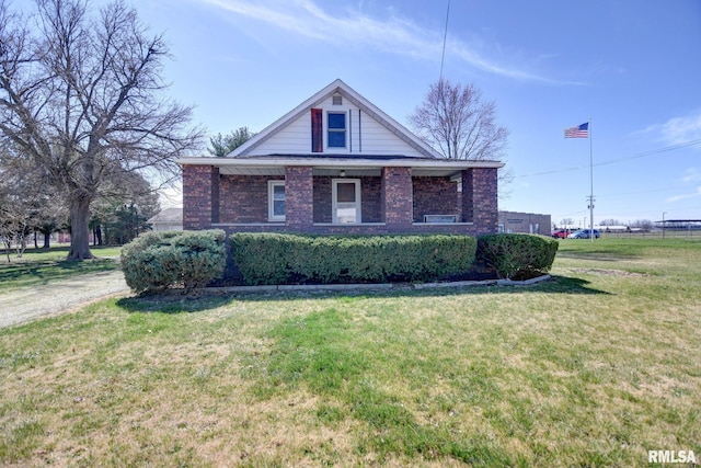 view of front of property with brick siding and a front lawn